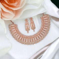 Dazzled with this beautiful Handcrafted SELMA rose gold Mint Green American Diamond Flexible Necklace and earring set. Pair them with any outfit and add a charismatic charm to your beautiful appearance, This item is delicately handcrafted for you. Dimension: Necklace width 3.5cm Earrings Drop Length 6cm Approx. Elegant Copper Necklace For Weddings, Elegant Copper Jewelry For Parties, Rose Gold Hand Set Necklace For Celebration, Rose Gold Jewelry Sets With Elegant Design For Party, Elegant Rose Gold Jewelry Set For Party, Hand Set Rose Gold Jewelry For Celebration, Rose Gold Jewelry Set With Elegant Design For Gifts, Rose Gold Cubic Zirconia Jewelry For Celebration, Hand Set Rose Gold Jewelry Sets For Celebration