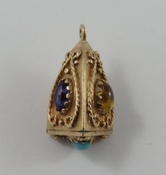 "This is a vintage \"Triangular Shaped Fob With Colourful Stones\" 10 karat gold charm for a charm bracelet. The fob has red, yellow, blue and turquoise stones. It weighs 6.25 grams and measures 1/2\" x 3/4\", tested 10K All charms come with a split ring to attach to a bracelet. We have hundreds of charms in stock. If you don't see what you are looking for in our shop please contact us as it is likely we have it. Inventory #G4870" Ornate Pendant Jewelry With Charms, Victorian Vintage Charm In Yellow Gold, Victorian Yellow Gold Vintage Charm, Vintage Yellow Gold Charms Stamped 14k, Vintage 14k Stamped Yellow Gold Charms, Heirloom Jewelry With Birthstone For Collectors, Heirloom Birthstone Jewelry For Collectors, Collectible Yellow Gold Charms With Vintage Charm, Collectible Yellow Gold Charms With Vintage Design