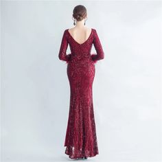 a woman in a long red dress is looking back