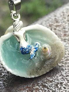 "Mermaid in a Shell Necklace, Beach Lover Gift, Mythical Fun Jewelry, Gift for her, unique necklaces for women, Gifts for Sister, Beach Wedding Handmade and unique Mermaid in a Shell necklace. Mermaid Bath This beautiful Mermaid in a shell necklace has been handmade by me using real sand a real seashell and resin. Be Unique, have an original design, This necklace will be a conversational piece. The water also glows in the dark if you leave it under a UV lamp or in the sunlight for a few minutes. Ocean-inspired Adjustable Charm Necklace Gift, Blue Charm Necklaces For The Beach, Whimsical Blue Pendant Jewelry, Whimsical Blue Charm Jewelry, Whimsical Blue Jewelry With Charms, Personalized Blue Bohemian Jewelry, Bohemian Mermaid Necklace For Gifts, Bohemian Mermaid Necklace Gift, Whimsical Blue Charm Necklace As Gift