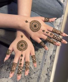 two girls with henna tattoos on their hands