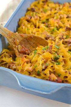 a blue casserole dish filled with pasta and meat