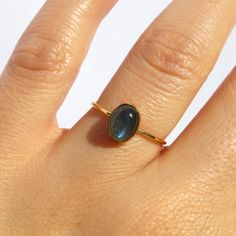 Beautiful, radiant and deep. The labradorite is known as the stone of transformation, enhancing strength and inner worth. This gold labradorite ring is made with a 14k gold filled band and frame. It balances and protects the aura. Whether you're buying this for yourself or as a gift, this handmade ring protects against negativity and promotes perseverance. Made in U.S.A. Fast Shipping: It will take 1-5 business days to send out your item Packaging: Comes in a gift box, ready for gift-giving Ring Oval Labradorite Promise Rings, Labradorite Birthstone Rings As A Gift, Labradorite Birthstone Rings For Gifts, Gold Rings With Labradorite Natural Stones, Yellow Gold Labradorite Ring For Gift, Moonstone Ring With Oval Labradorite, Ring Simple Gold, Simple Gold Ring, Gemstone Ring Silver