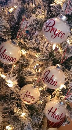 a christmas tree with ornaments that say merry and have names on them