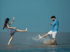 two people in the water kicking each other up and one person is holding his leg