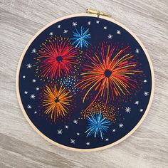 an embroidery project with fireworks in the sky