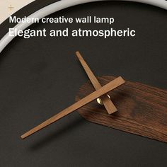 a wooden clock with the words modern creative wall lamp elegant and antmospherric