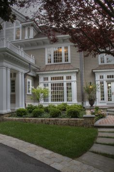 a large house with white trim and windows