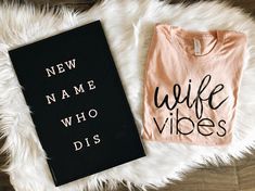 a book and t - shirt laying on top of a fur rug with the words'new name who dis '