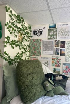 there is a stuffed animal on the bed in this room with many pictures and plants