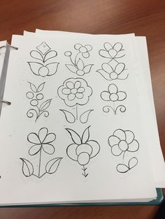 an open notebook with flowers drawn on it