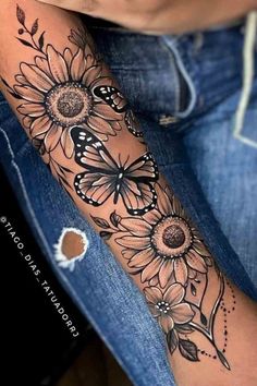 a woman's arm with sunflowers and butterflies on it