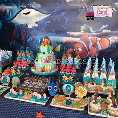 an under the sea themed birthday party with cake and cupcakes, decorations and more