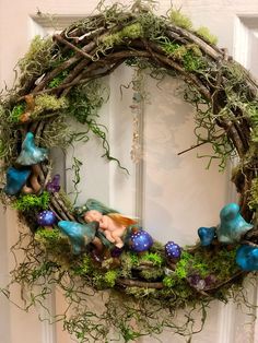 a wreath with moss, blue and green decorations