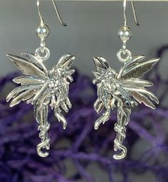 "Solid Sterling Silver - These sweet little solid sterling silver fairy earrings will make you smile. With long flowing hair and detailed wings, they will dance around your head and into your heart. A beautiful gift for anyone who still believes in the magical side of the world! Fairies symbolize spirituality, feminine energy, childhood and beauty in all its shapes and forms. No matter how old you are or how much you believe in things like fairies, these earrings can be a beautiful symbol for ev Silver Fairy, Fairy Earrings, Wee Folk, Tree Of Life Jewelry, Sweet 16 Gifts, Flowing Hair, Beautiful Symbols, Celtic Knot Ring, Gift Sister