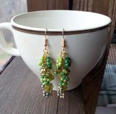 Beaded Flower Earrings in Shades of Green Hand beaded flowers connected to create this fun pair of earrings. They are approximately 2 3/4 inches. Green Flower Beaded Earrings Gift, Green Bohemian Beaded Flower Earrings, Green Beaded Drop Flower Earrings, Green Flower Earrings With Dangling Beads, Green Flower-shaped Beaded Earrings, Hand Beading, Beaded Flowers, Flower Earrings, Shades Of Green