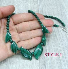 "Genuine Malachite gemstone beaded necklace, made of dark green stone beads in round and leaf shapes. Natural malachite jewelry, dainty bib necklace. Length: from 18 and 19 \" ( 46 and 48 cm ) - can be shortened on request. Beads: 4 mm balls and leaves measuring from 15 to 30 mm long. Please see all photos and select the style: Style 1 - the necklace with wider spread leaves, 19 inches long. Style 2 - the necklace with darker leaves placed closer together and making more V-shape, 18 inches long. Green Malachite Gemstone Bead Jewelry, Green Malachite Jewelry With Gemstone Beads, Malachite Gemstone Bead Necklaces, Malachite Gemstone Beads Necklace, Adjustable Malachite Gemstone Beads Jewelry, Malachite Gemstone Necklaces With Round Beads, Malachite Gemstone Round Beads Necklace, Malachite Gemstone Necklace With Round Beads, Beaded Malachite Round Bead Necklaces