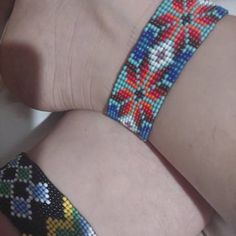 two bracelets made out of beads on someone's arm