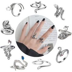 many different rings are arranged around a woman's hand and the ring is on top of an open book