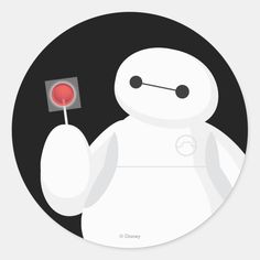 a round sticker with an image of a white robot holding a red object in it's hand