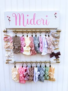 there is a sign that says midori and many different bows hanging on the wall