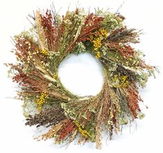 a dried wreath with yellow and red flowers on it's front end is displayed against a white background