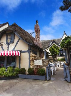 a small building with a red and white striped awning on the front entrance to it