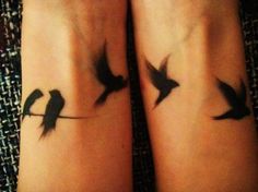 two birds on a branch tattoo on both legs