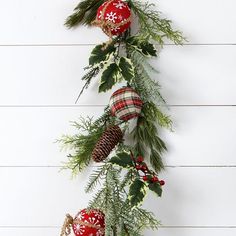 christmas decorations hanging on the side of a white wall