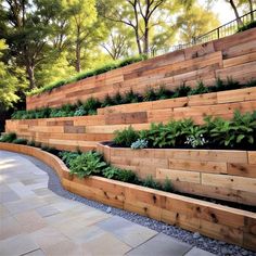 an outdoor garden with wooden steps and plants growing on the sides, along with stone pavers