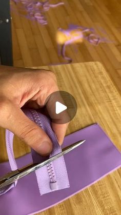 a person cutting fabric with scissors on a table