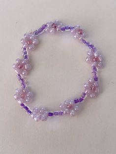 the bracelet is made with glass beads and purple stones, along with an amethorate bead