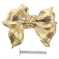 a large gold bow with a screw in the middle and two smaller bows on each side