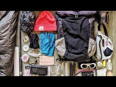 the contents of a backpack are laid out neatly