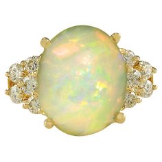 Stamped: 14K Yellow Gold Total Ring Weight: 7.5 Grams Total Natural Opal Weight is 6.07 Carat (Measures: 14.00x12.00 mm) Color: Multicolor Total Natural Diamond Weight is 0.60 Carat Color: F-G, Clarity: VS2-SI1 Face Measures: 14.75x20.70 mm Sku: [702057W] Yellow Gold Diamond Ring, Gold Diamond Ring, La Face, Emerald Engagement Ring, Gold Diamond Rings, Natural Opal, Opal Jewelry, Birthstone Jewelry, Cocktail Rings