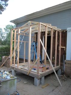 an unfinished house being built in the yard