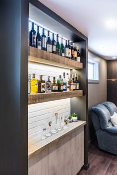 a living room filled with furniture and lots of bottles