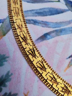 Step back into the glamour of the 1970s with this stunning vintage 18 carat gold-plated bracelet, a true statement piece of retro elegance. This wide bracelet features a diamond-cut engraved chevron pattern that beautifully reflects light, adding a dazzling touch to any outfit. The delicate rope chain detailing along the edges adds sophistication and texture, making this bracelet stand out as a unique piece of vintage costume jewelry. Crafted from high-quality gold-plated base metal, this bracel Vintage Gold Plated Bracelets For Formal Occasions, Collectible Gold Jubilee Bracelet Jewelry, Vintage Yellow Gold Tarnish-resistant Bracelet, Vintage Tarnish Resistant Yellow Gold Bracelet, Vintage Tarnish-resistant Yellow Gold Bracelet, Retro Gold Bracelets As Gift, Vintage Yellow Gold Plated Bracelet, Vintage Gold-plated Yellow Gold Bracelet, Vintage Yellow Gold-plated Bracelet