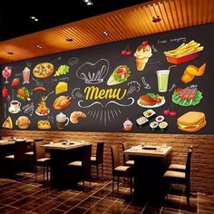 a restaurant with a large chalkboard wall that says menu written on it and lots of food