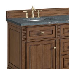 a bathroom vanity with marble top and two faucets on the sink cabinet doors