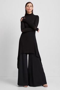 Peak "minimalism with an edge" at your service. Handcrafted from our beloved sheer European jersey, Stef is a relaxed-fit tunic featuring a turtleneck and long sleeves complete with cuffs and thumbhole. Her asymmetric hem gives an added level of flowing sophistication with day to night versatility: layer her over leggings for an effortless athleisure look, or pair her with wide-leg pants for maximum drama.[SPLIT] Julia, in black, is 5'10" (178 cm) tall, wearing size XS. Natalee, in anthracite, i Elegant Wide Leg Pants, Long Top With Pants, Classy Outfits Black, Effortless Athleisure, Tunic Dress With Leggings, Classy Black Outfits, Minimalism Outfit, Asymmetrical Fashion, Malaysia Fashion