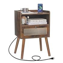 a wooden table with an electronic device on top and books in the bottom shelf next to it