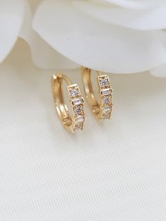 Beautiful solid 14k yellow gold Bagguete and round CZ Huggies Earrings. Perfect for everyday and every occasion. Modern, unique and versatile. Will match any outfit. 14k gold will not tarnish or rust. Materials: 14k gold, cubic zirconia diamonds Diameter: 12.5mm Width: 3mm Weight: 1.5 Grams 14k gold stamped Fast shipping Follow us for more fine 14k Gold jewelry Contact me with all your questions i will be happy to help 14k Gold Hoop Earrings With Baguette Diamonds, 14k Gold Baguette Cut Diamond Earrings For Wedding, Wedding Diamond Earrings 14k Gold Baguette Cut, Wedding 14k Gold Baguette Cut Diamond Earrings, Yellow Gold Round Earrings With Baguette Diamonds, 14k Gold Huggie Diamond Earrings For Wedding, Cubic Zirconia Huggie Earrings With Baguette Diamonds As Gift, Hallmarked 14k Gold Huggie Earrings For Wedding, 14k Gold Baguette Diamond Earrings