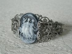 Triple Goddess Cuff Bracelet This beautiful silver plated filigree cuff bracelet has silver plated filigree accents and a triple goddess cameo. Adjustable. Silver Gothic Cameo Jewelry, Silver Cameo Bracelet For Gifts, Elegant Silver Bracelet With Cameo, Vintage Silver Cameo Bracelet, Cuff Bracelets Silver, Jewelry Magic, Wicca Jewelry, Galaxy Jewelry, Double Rings