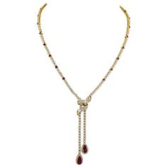 A beautiful and elegant necklace adorned with baguette and round diamonds. Two pear-shape rubies suspending from the chain weighing around 2 carats each. 24 square-cut rubies are set all over the chain. Approximate total weight is 3.6 carats, 0.15 carat each ruby. Baguette and round diamonds weighing a total of approximately 18-20 carats. The diamonds are equivalent to G-H colors, VS-SI clarity. The metal is 18k yellow gold, gross weight 40.77 grams. All rubies and diamonds in the necklace are n Yellow Diamond Necklace, Ruby And Diamond Necklace, Gold Drop Necklace, Rubies And Diamonds, Drop Necklaces, Diamond Drop Necklace, Jewelry Ruby, Big Jewelry, Gold Diamond Necklace