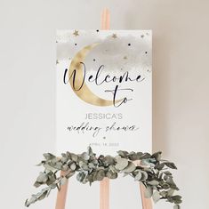 a welcome sign on top of a wooden easel