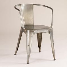 a metal chair sitting on top of a white floor