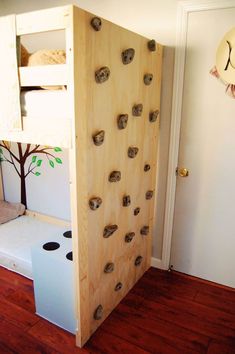 a bunk bed made out of plywood boards with holes in the bottom and sides