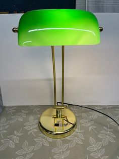 a green lamp sitting on top of a table