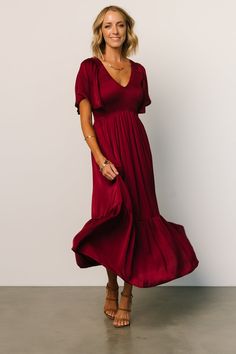 Beautiful deep wine color Soft satin-like material Rounded V neckline Smocked bodice with flutter sleeves Mid length midi style with semi pleated ruffle hem Lined from waist down Bump friendly 100% Polyester Trina is 5'6, cup size 32C, size 2 and is wearing size S Solid V-neck Midi Dress With Smocked Back, Elegant V-neck Smocked Dress For Brunch, Solid Color Ruched Midi Dress With Flutter Sleeves, Elegant Smocked Dress With Flutter Sleeves, Solid Color V-neck Midi Dress With Smocked Back, Solid Color Ruched Midi Dress With Empire Waist, Elegant Smocked Dress With Ruched Empire Waist, Elegant Smocked Dress With Ruched Detail And Empire Waist, Elegant Solid Color Smocked Midi Dress